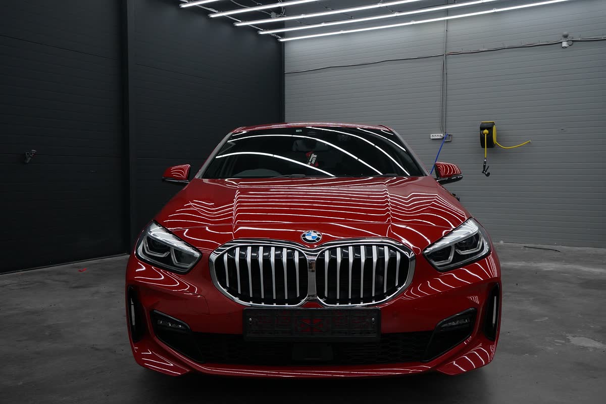 Красная BMW 1 серии спереди в боксе